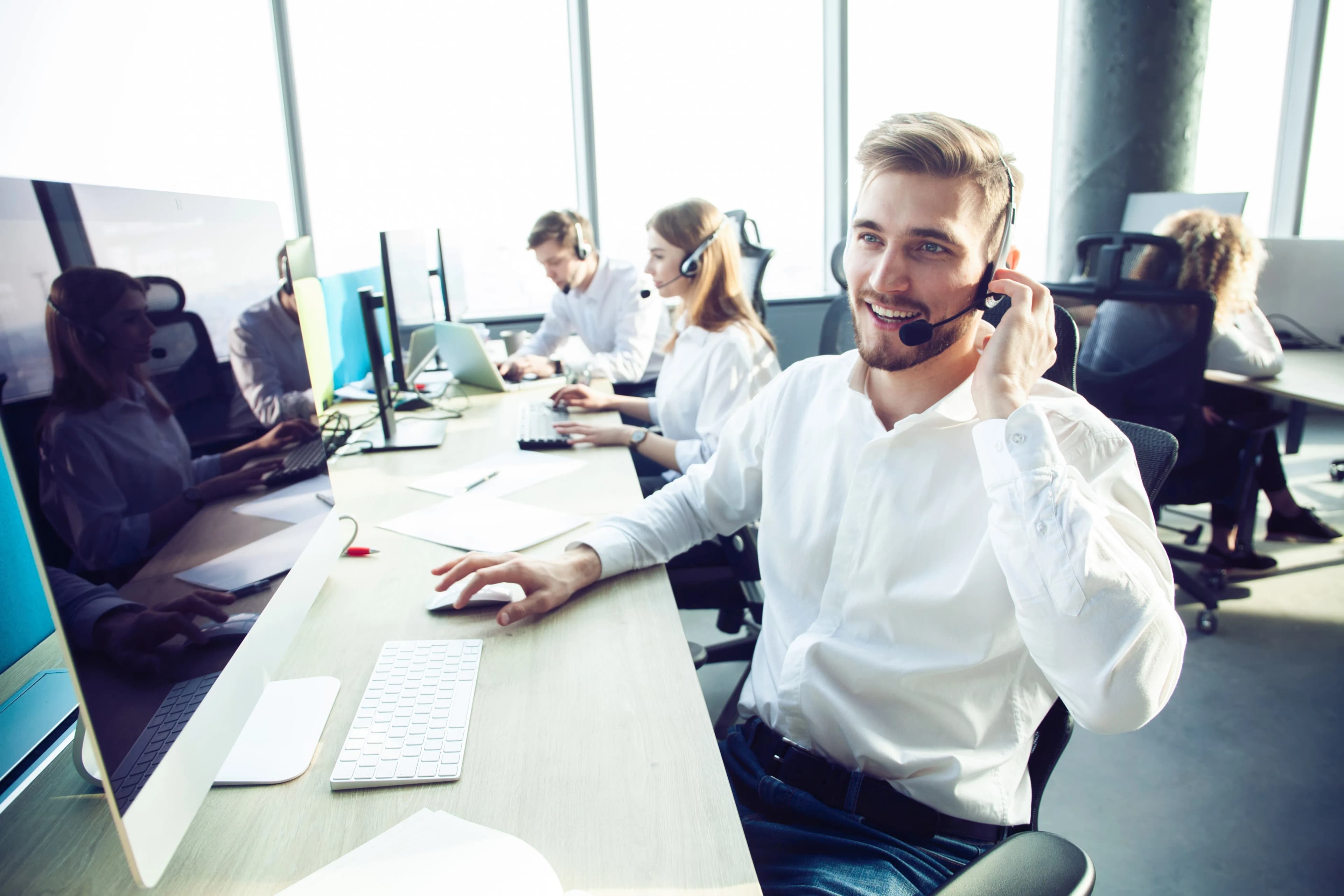 A man wearing a headset and a white shirt.